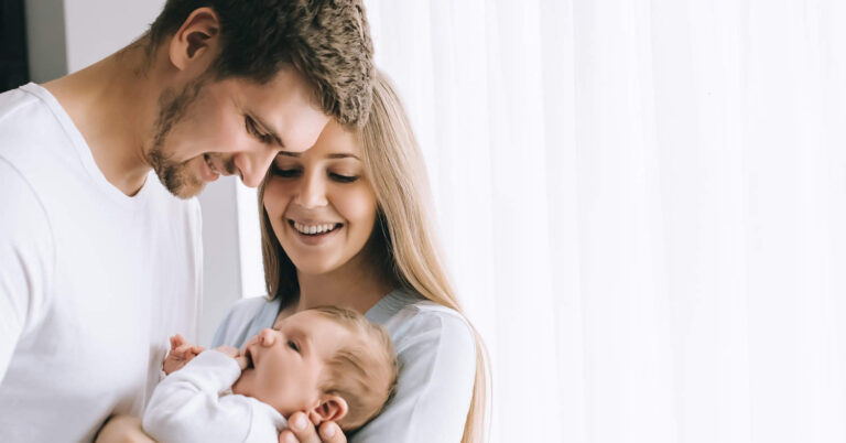 Mother and father holding newborn baby